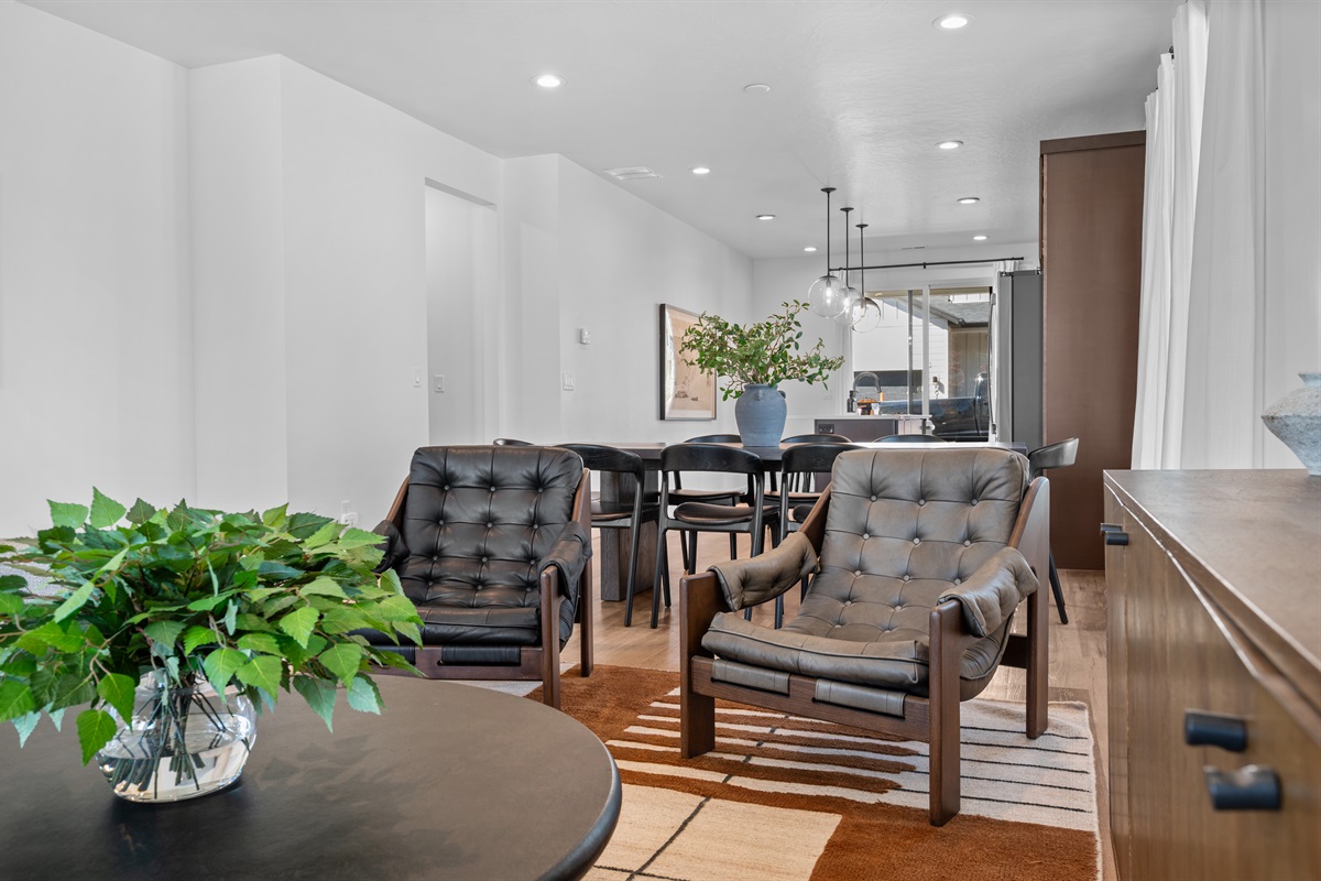 Modern design meets comfort with chic seating, earthy tones, and curated décor for an elevated yet cozy