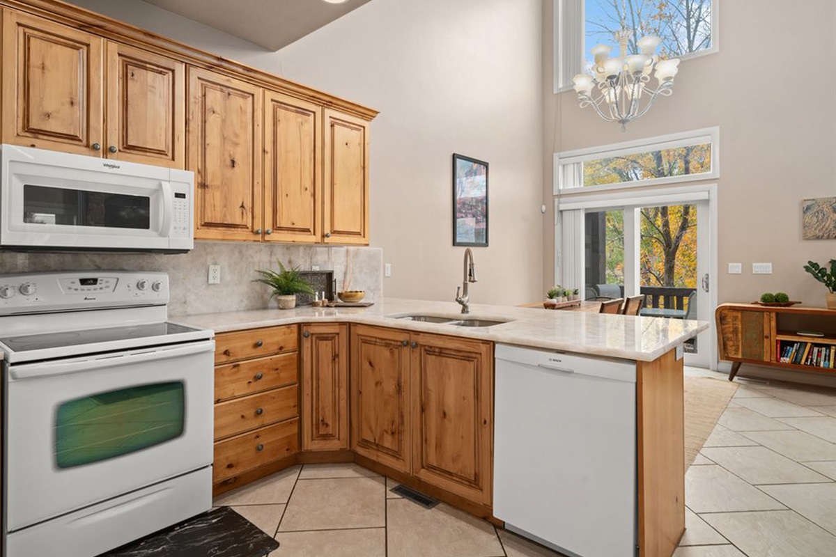 Fully equipped kitchen with generous counter space and natural light.