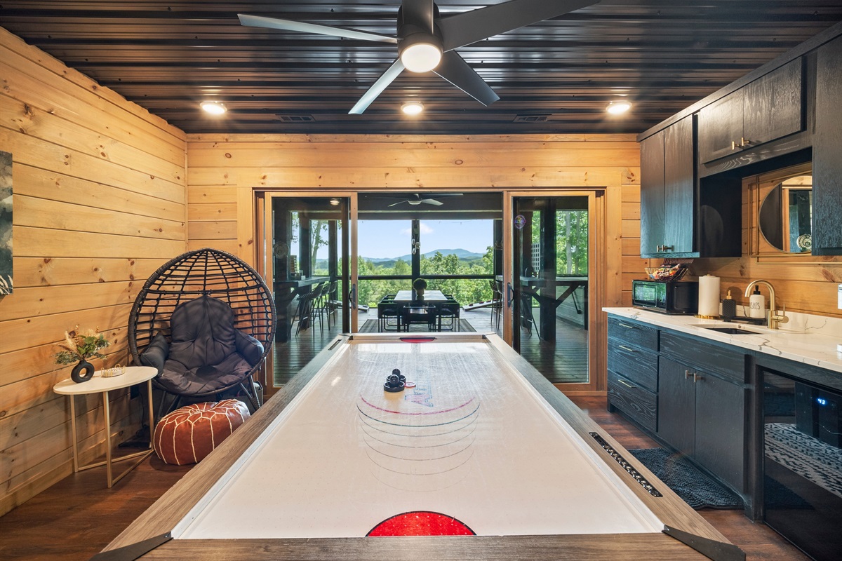 This stylish recreation area invites friendly competition with a full-size air-hockey table.