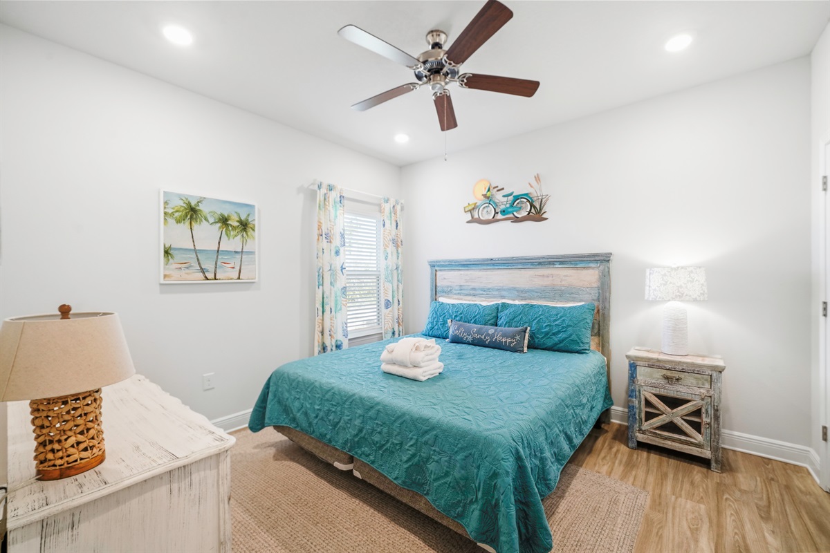 MIL Bedroom: Beach-Themed King bedroom with, drawer, ceiling fan & Nightstands