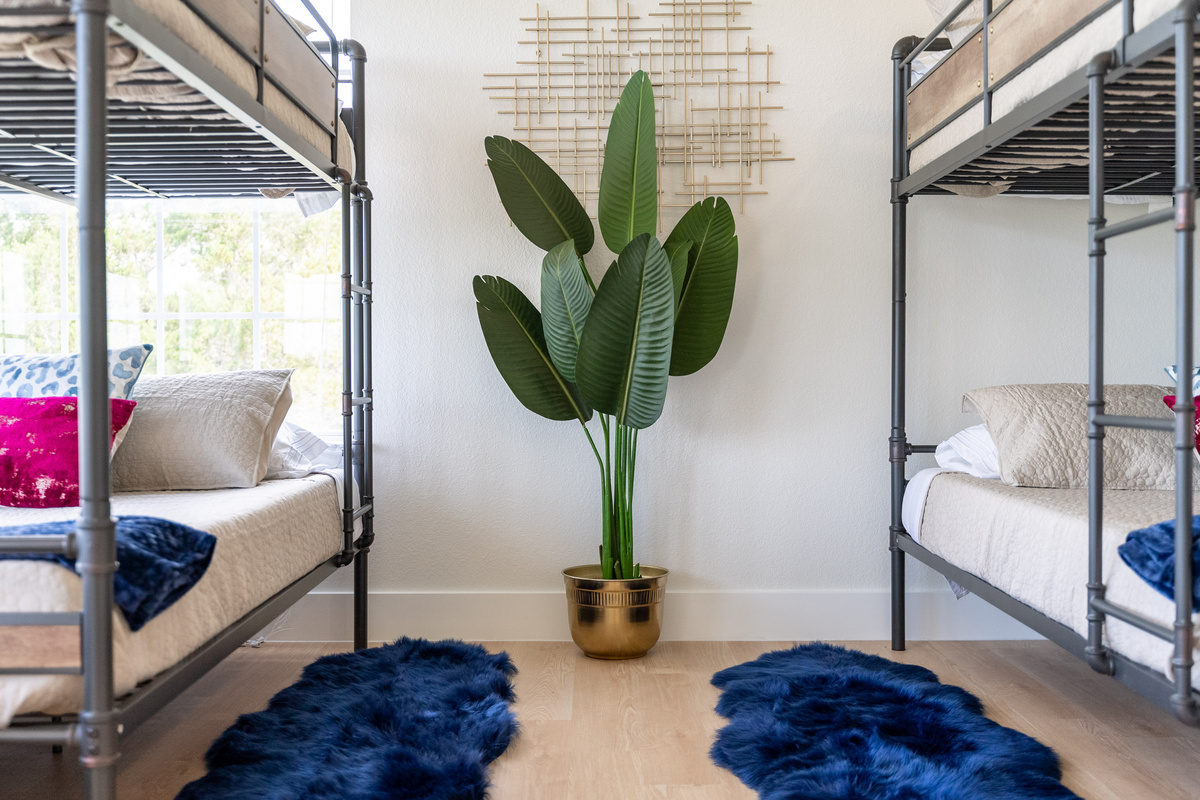 A queen-over-queen bunk adds flexible sleeping space to the primary suite.