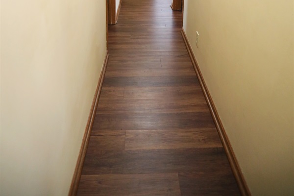 Hallway showing two bedrooms to the left, master suite to the right and second full bathroom straight ahead