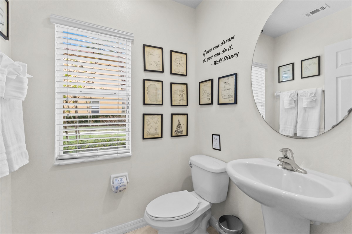 Convenient downstairs half bathroom near living space. You will appreciate the wall art that show the original Disney ride designs.  