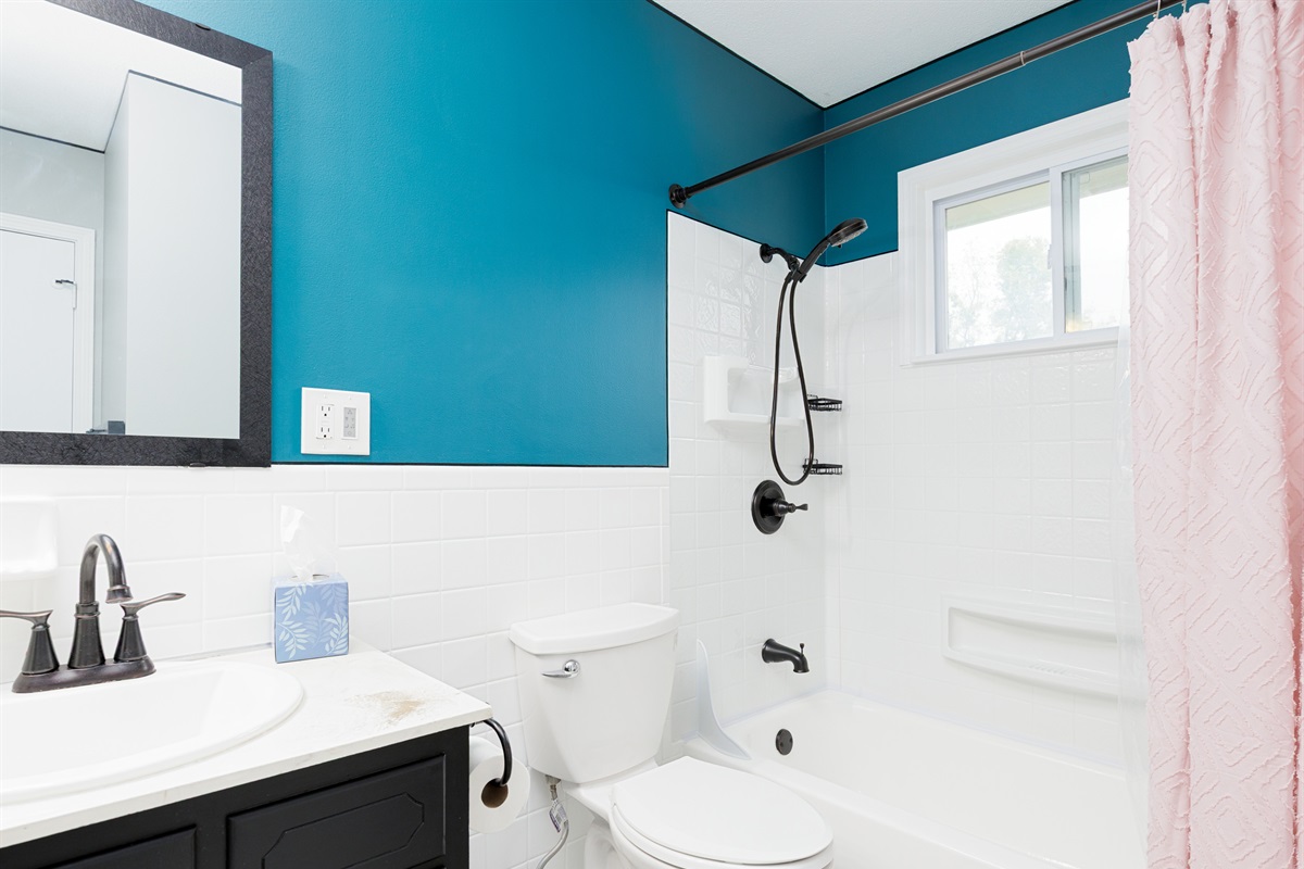 Main floor bathroom featuring a shower and clean, modern fixtures.