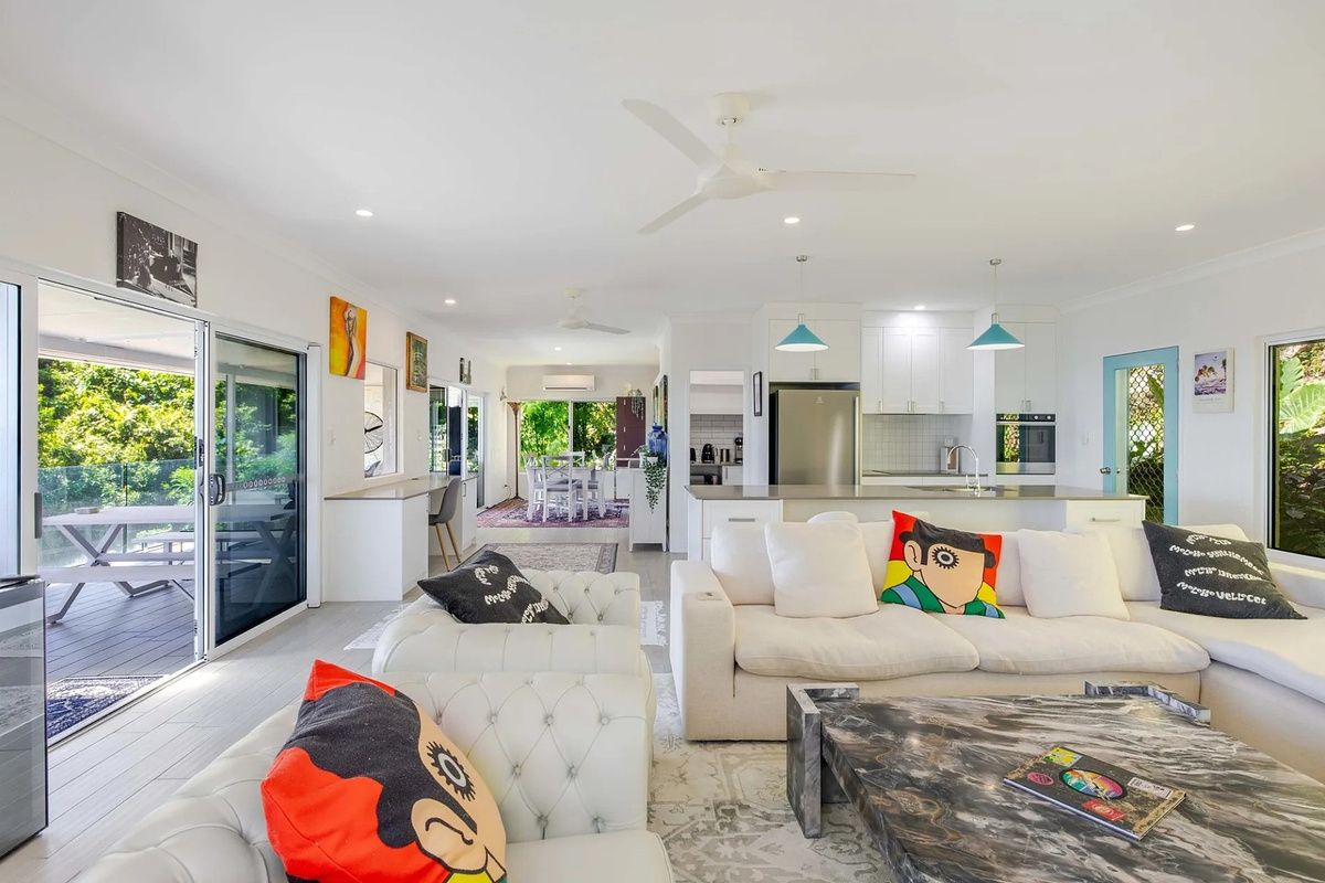 The open-plan lounge, kitchen and dining area gives your stay a bright central space, with sliding doors connecting directly to the deck.