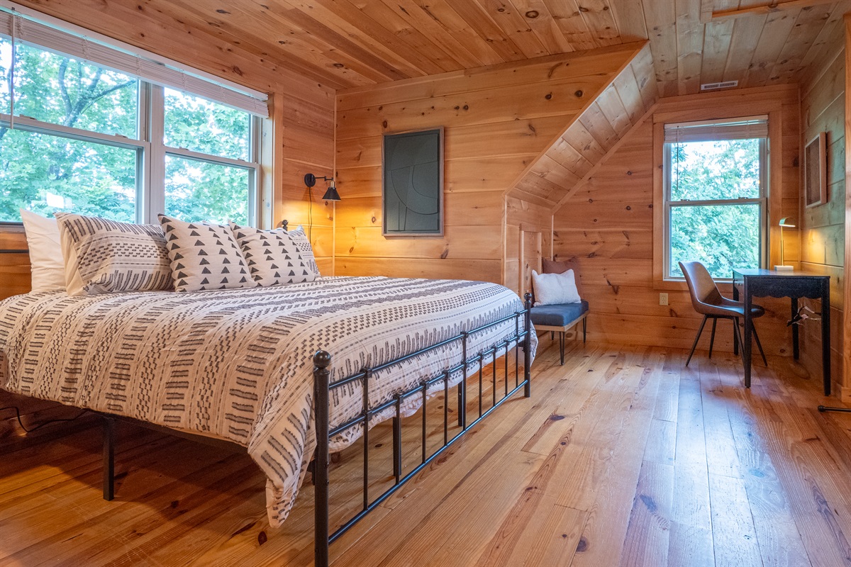 The top-level primary bedroom has plenty of space to spread out and relax. It's your personal haven in the mountains!