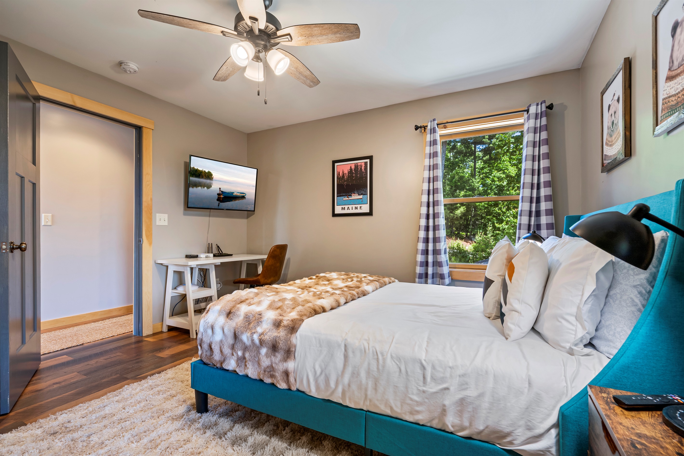Located on the main floor, the first bedroom offers a comfortable queen bed and work space.
