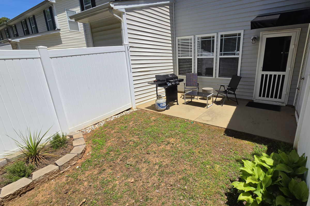 Backyard with outdoor seating and grill