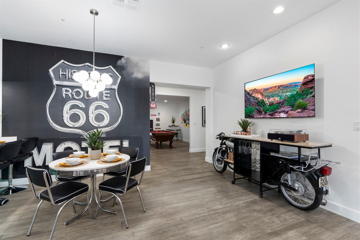 Retro Mural & Nostalgic Design- Record Player & Drink Making Amenities on the bike bar; Small dining for 4 (shown) + 3 bar stools + dining for 8 (behind the photo)