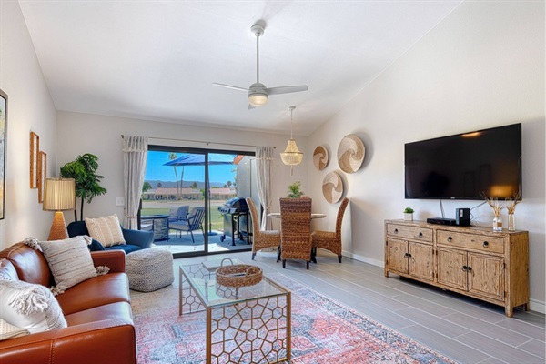 Villa living room with patio access and golf course view