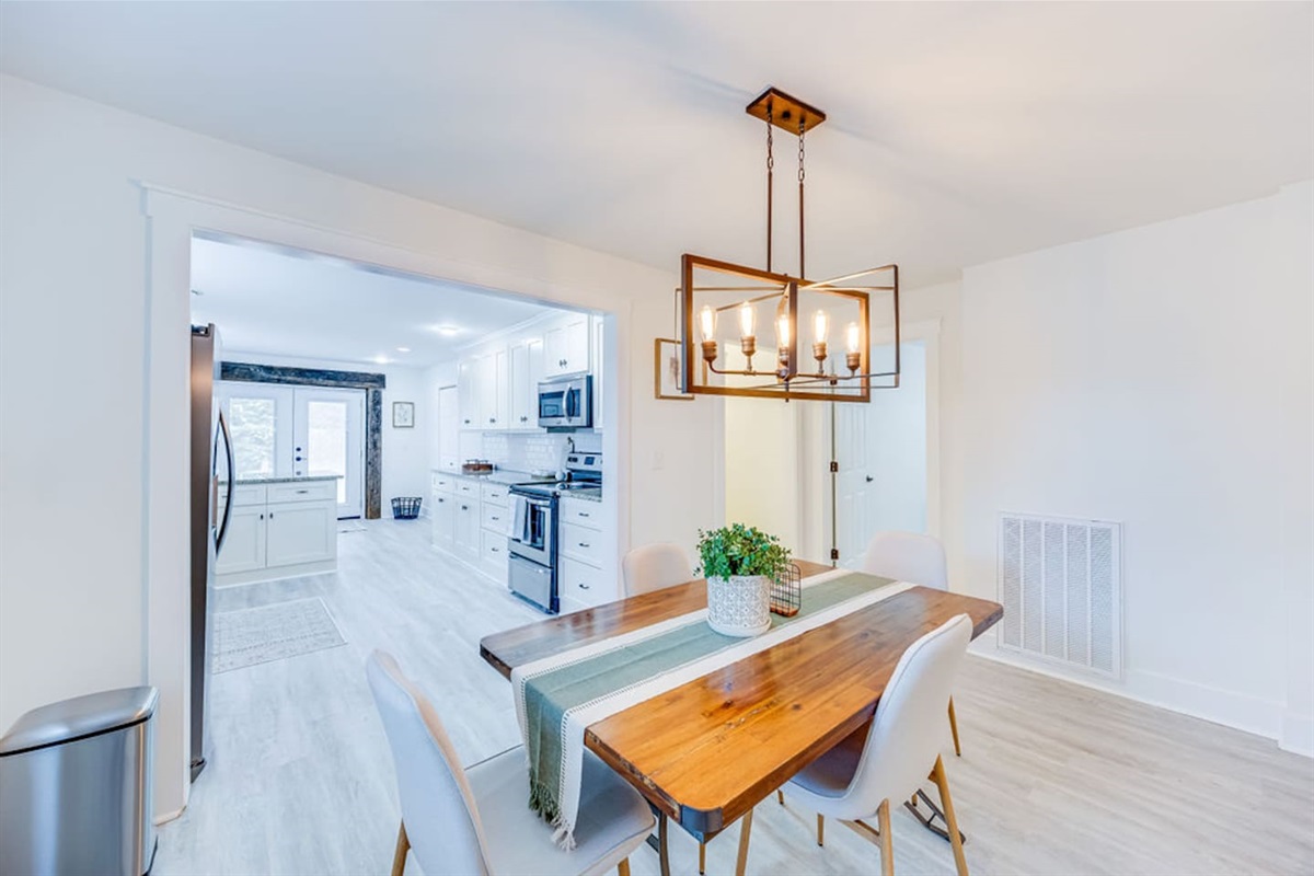 Elegant dining area with a beautiful chandelier, creating a warm and inviting atmosphere for every meal.
