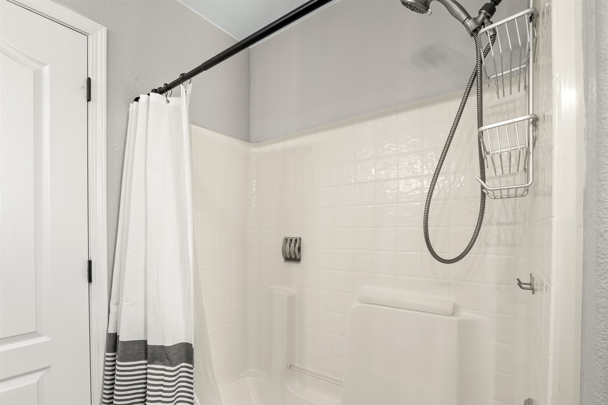 Bright and spacious shower/tub combo with built-in seating and easy access—perfect for kids and convenient for the whole family.