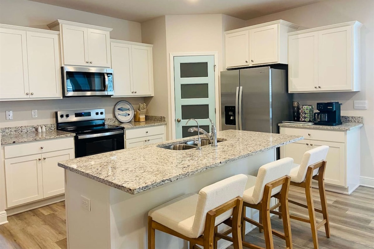 Modern, fully-equipped  kitchen with dual coffee maker and all essentials for cooking beachside feasts. 