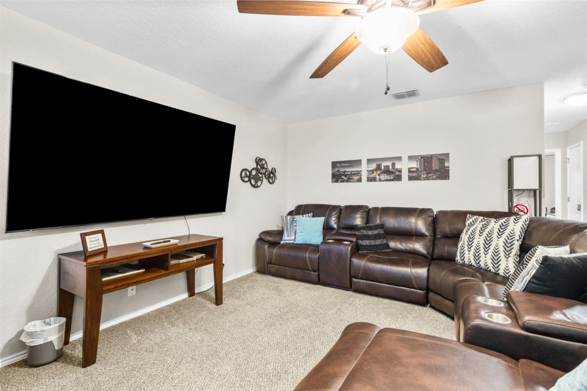 Family-friendly game room with Pac-Man arcade, board games, comfy seating, and a big-screen TV setup ideal for movie nights.
