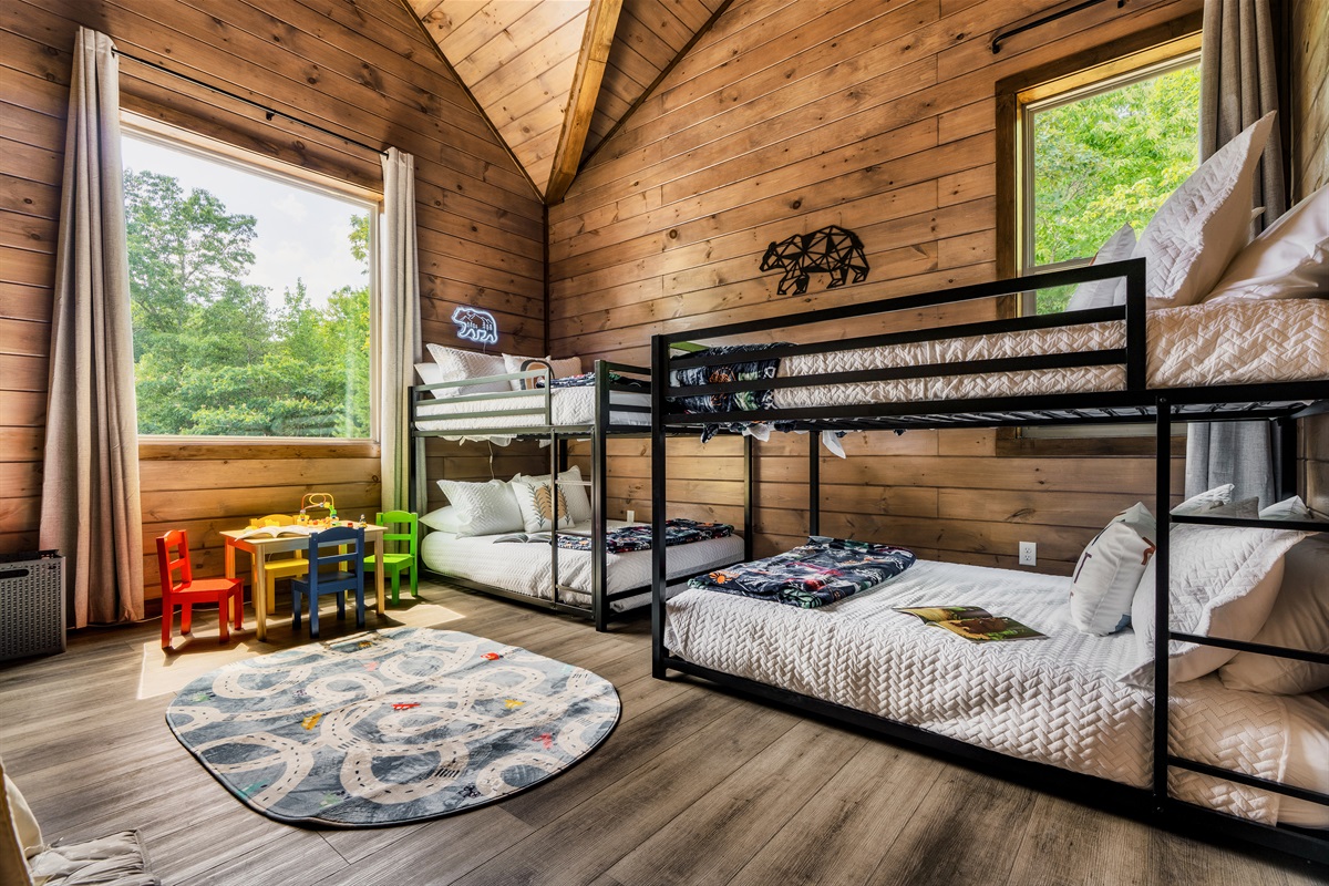 Family-friendly kids’ room with bunk beds, toy table, and cheerful vibes.