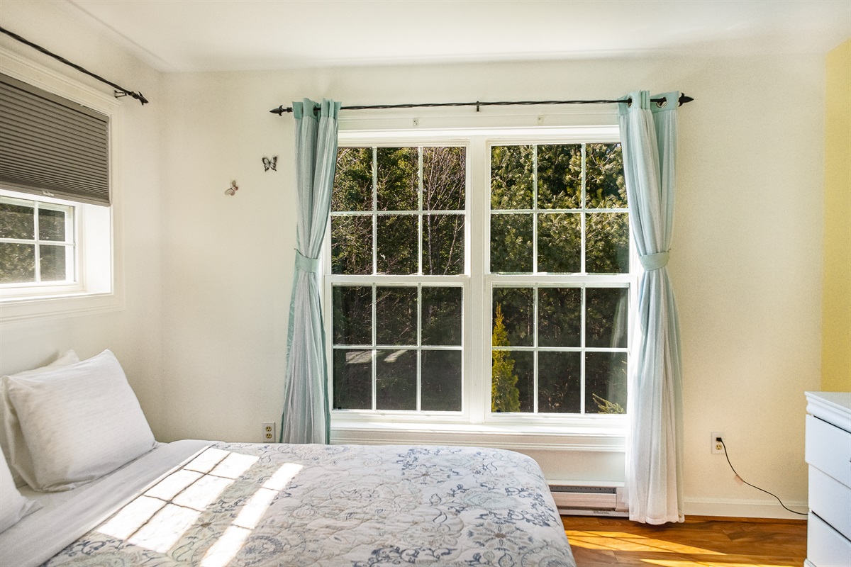 Wake up to tranquil wooded views from the Butterfly Room. For your total comfort, this guest room features a dedicated AC unit during the summer months, ensuring a cool and restful retreat after a sunny day exploring Acadia National Park.