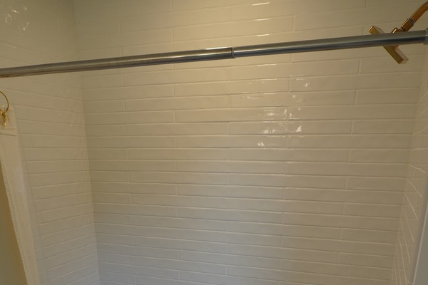 The second floor guest bathroom features a full size tub.
