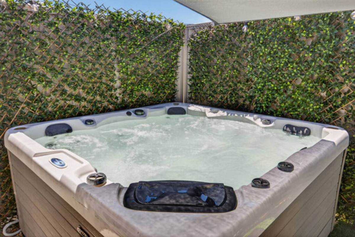 Soak in your own private spa under a shade sail, screened by greenery with festoon lights overhead for evening dips.