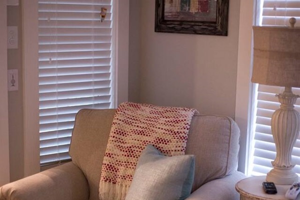 Chair in living room by rock fire place