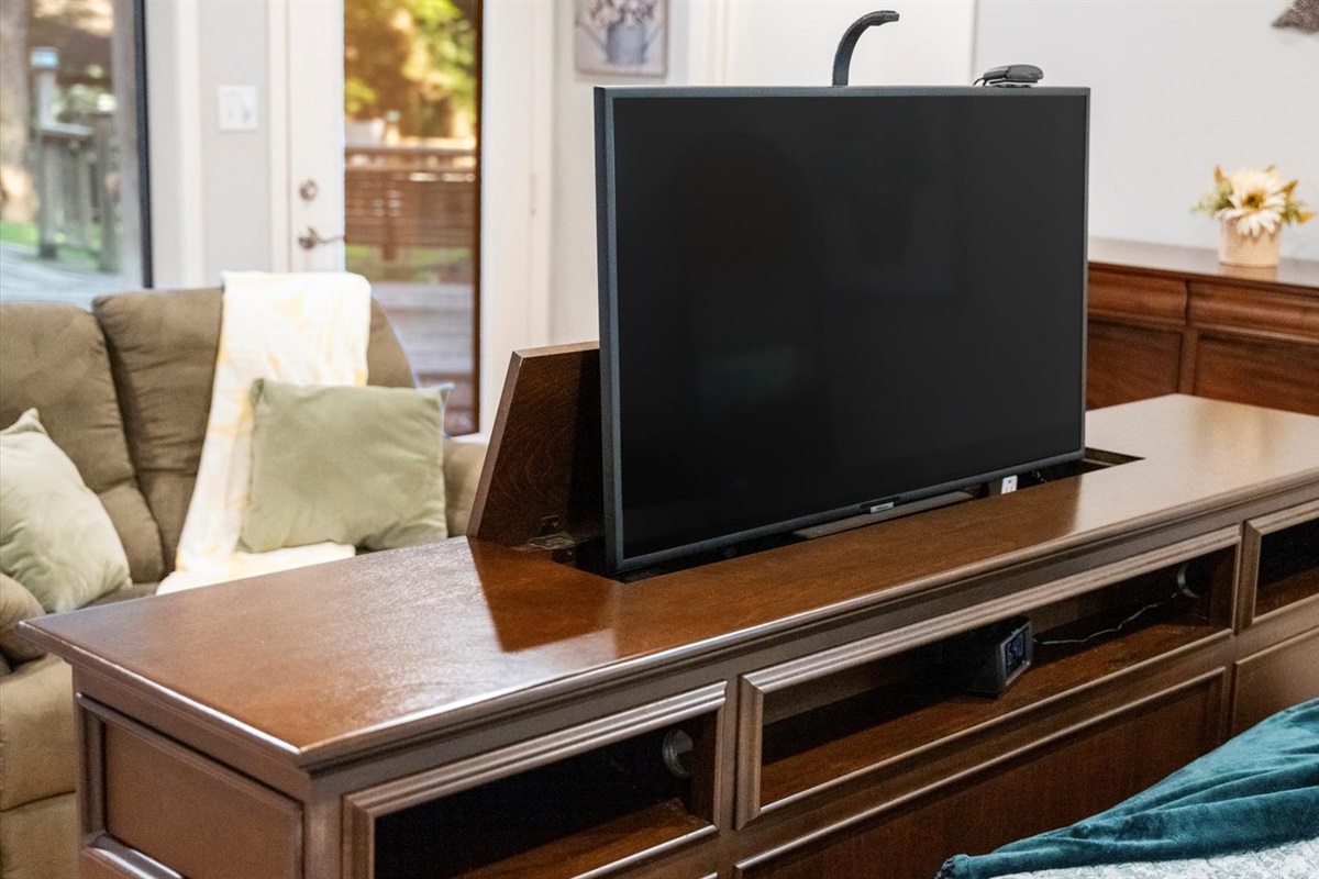 King 1 bedroom features a luxurious bed with a built-in footboard TV lift. Relax in comfort and enjoy your favorite shows with the touch of a button in this cozy and elegant retreat!