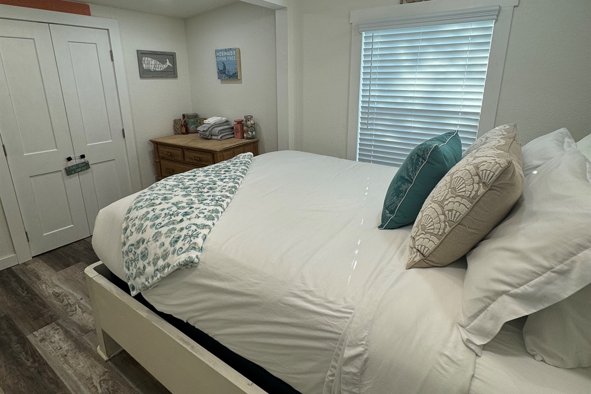 Bedroom with queen bed and smart tv