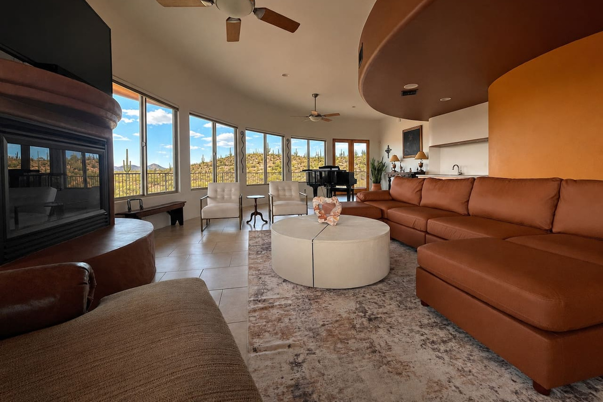 This open living room brings the sectional, fireplace, and piano together in one inviting shared space.