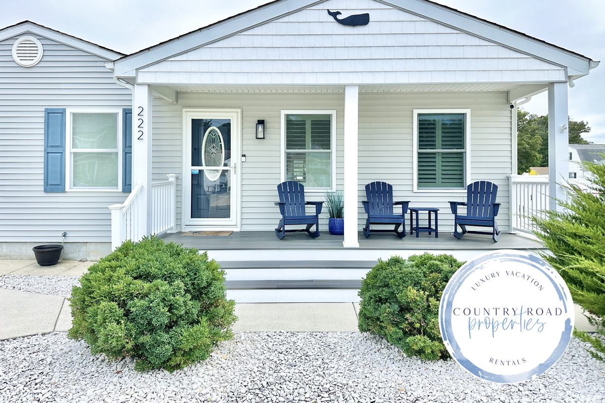 Welcome to your coastal escape, featuring a charming covered front porch with comfortable Adirondack rockers. This inviting entrance is the perfect spot to enjoy your morning coffee or feel the ocean breeze while taking in the quiet neighborhood views.