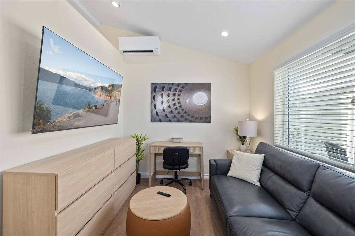 Living Room: Big Screen Smart TV, Workspace Desk, Large Leather Couch