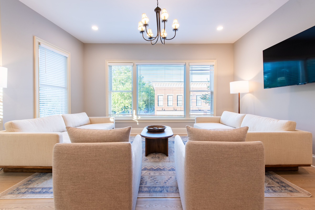 Sink into comfortable seating overlooking Meeting Street, with a mounted Smart TV and plenty of natural light.