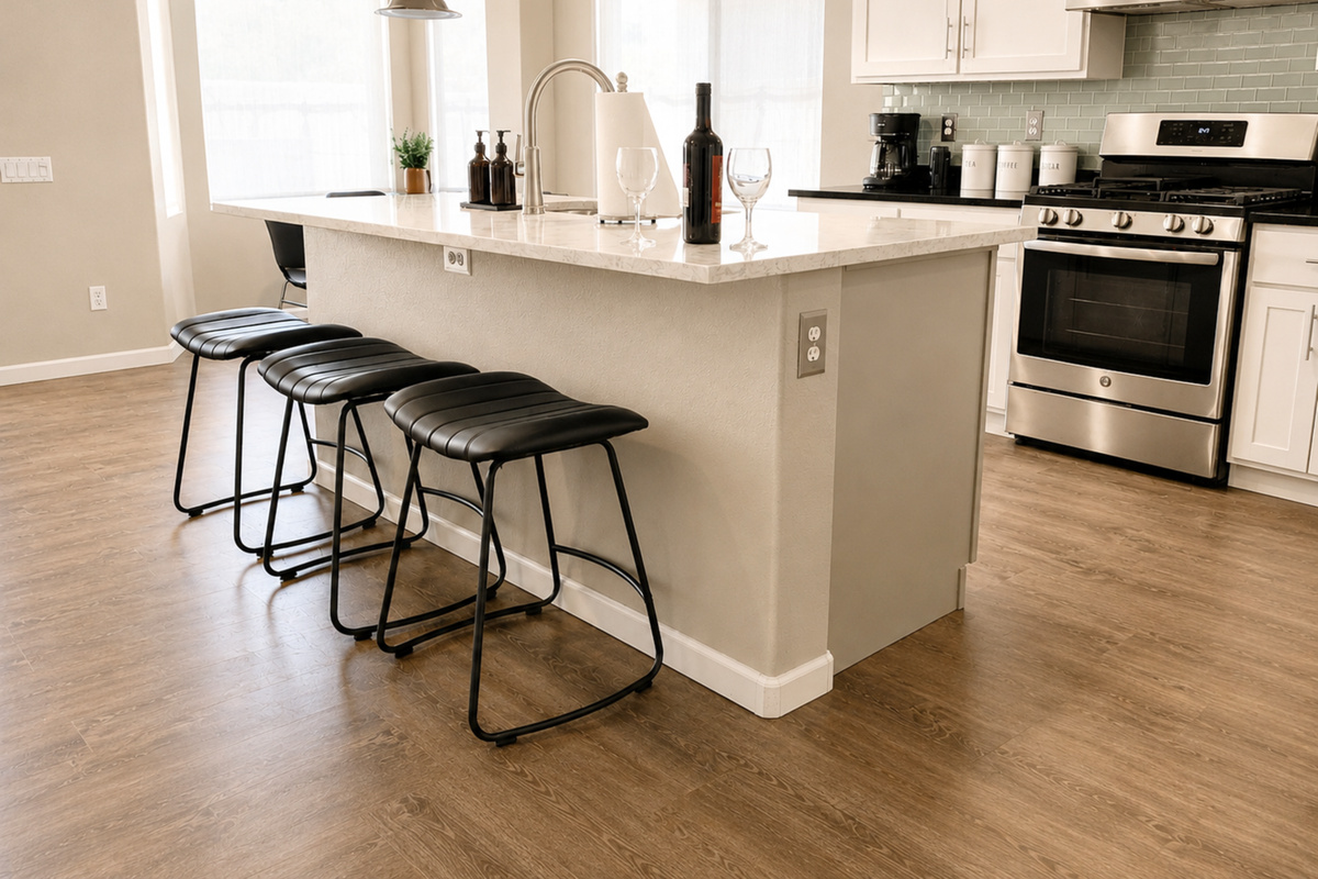 Sleek kitchen island with bar seating and stainless steel appliances — a perfect place for wine and conversation.
