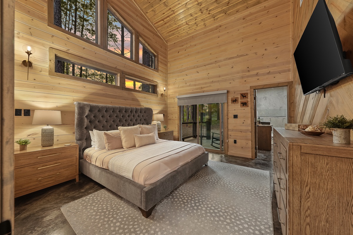 Bedroom 2 with luxury bedding, and private access to a porch for your morning cup of joe or nightly glass of wine.