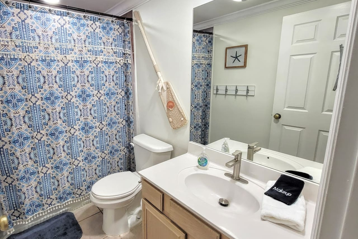 The main floor full bath keeps the queen bedroom and living area guests covered &mdash; clean, complete, and entirely theirs.