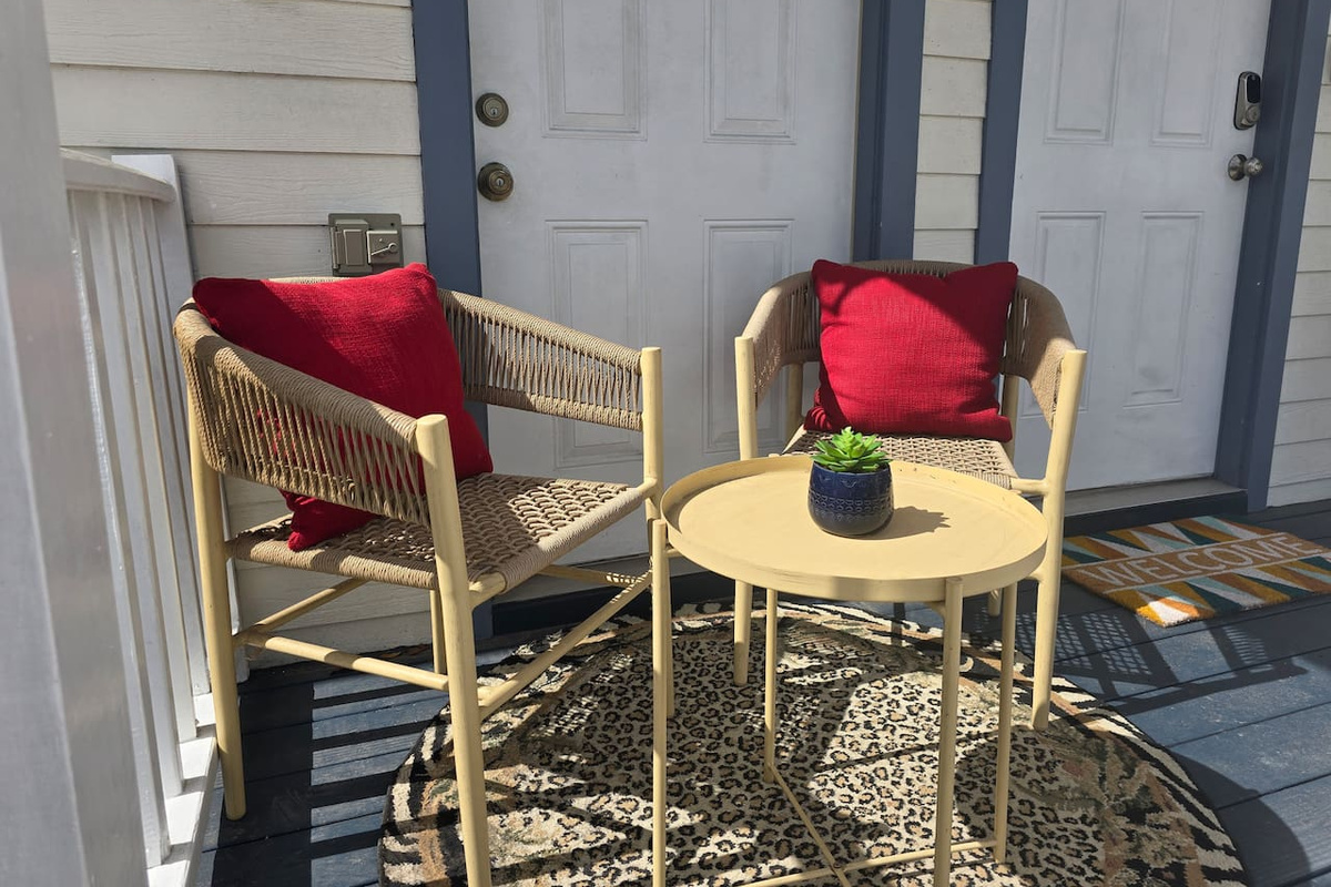 You won't be able to stop smiling as you enjoy tropical breezes and a beverage from the front porch. You'll see the runners and bikers, and maybe even a marching band, passing by on the greenway across the street!