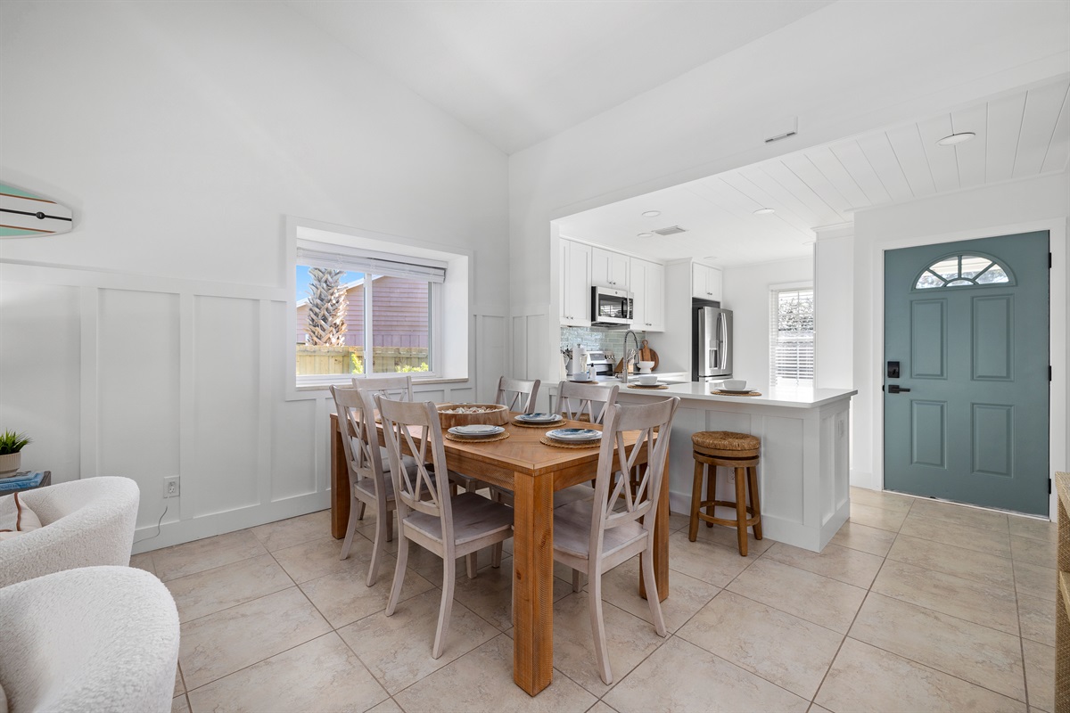 An open, sun-filled dining space that flows seamlessly into the kitchen &mdash; perfect for family meals, game nights, and vacation memories