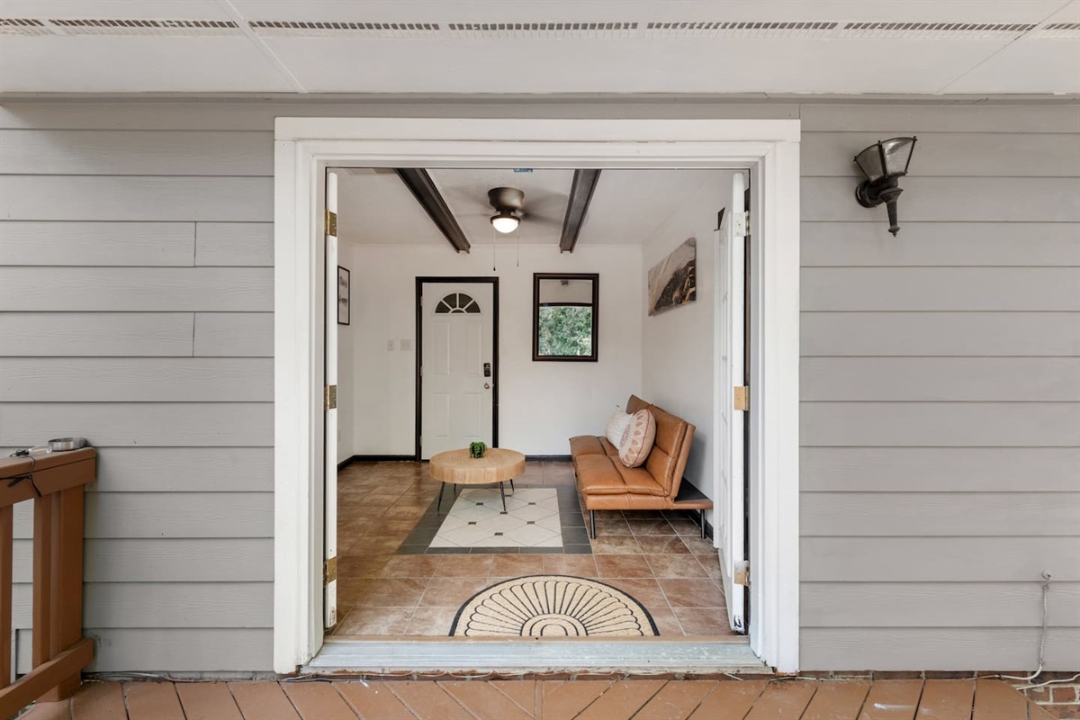 Covered entryway offers a smooth transition from outside to in — ideal for unloading, morning coffee, or a shaded moment of calm. 
