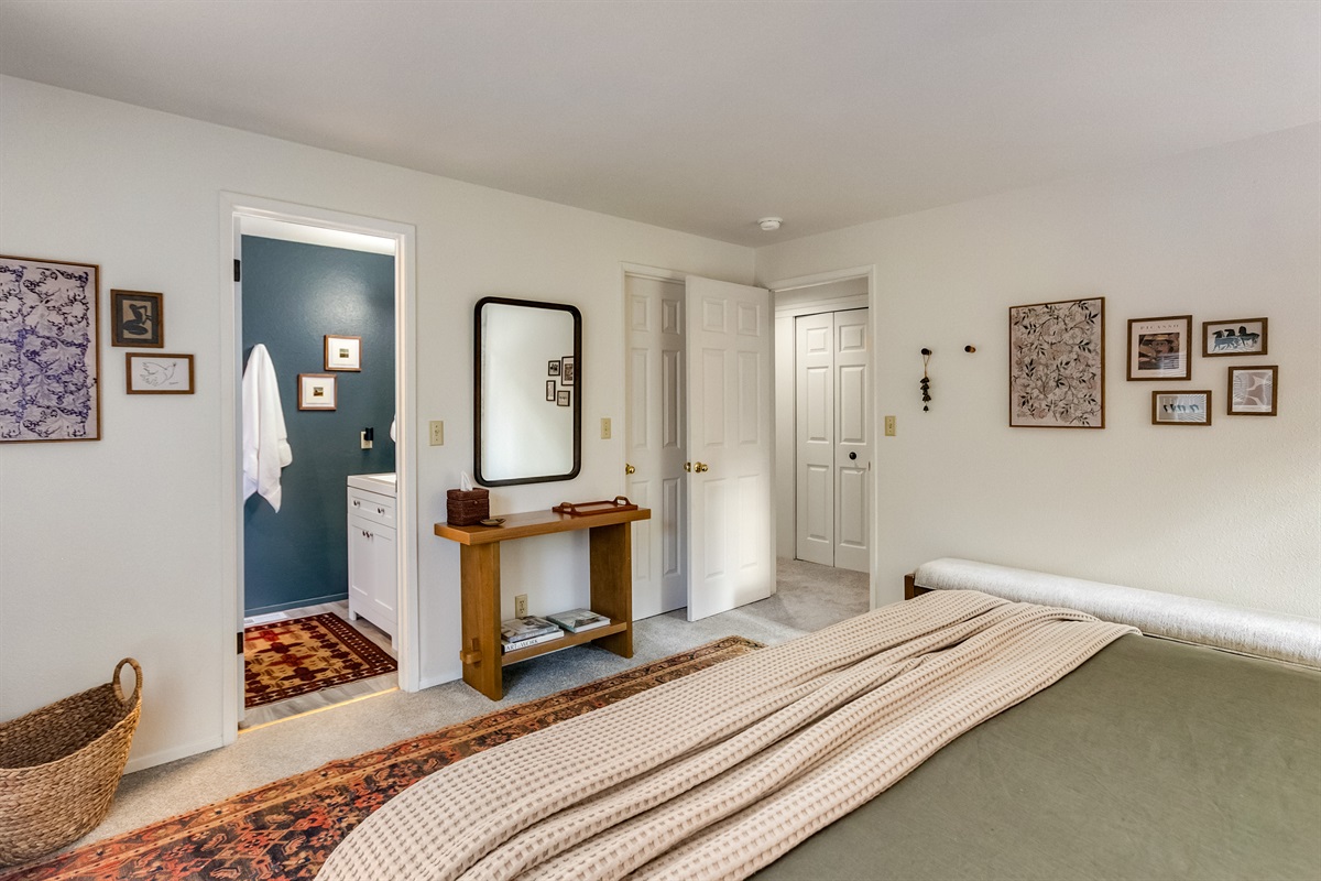 The upstairs primary suite features a king bed and en suite bathroom with a spacious closet.