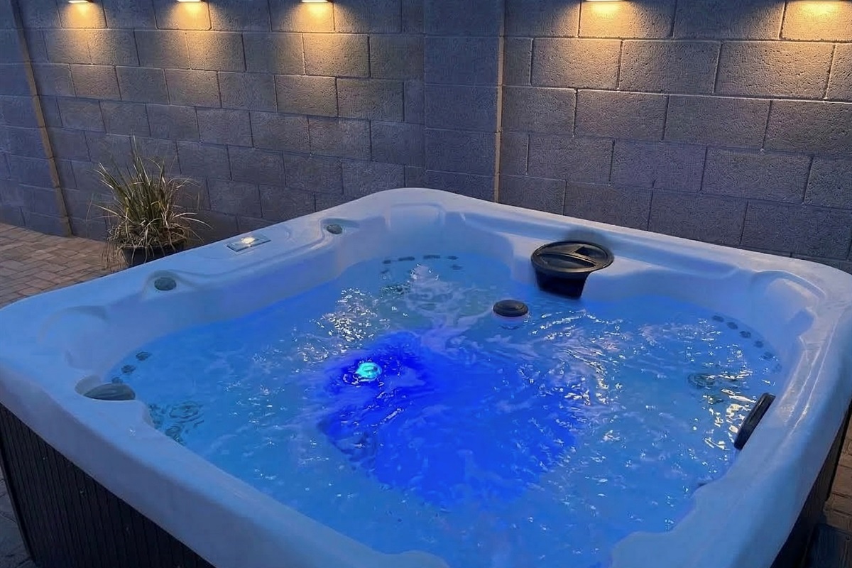 Hot tub is just one of amenities in the backyard. There is also a swimming pool that can be heated for an add'l fee; a large gas fire pit; ping pong; putting green; dining table; TV; Corn Hole; Giant Connect Four