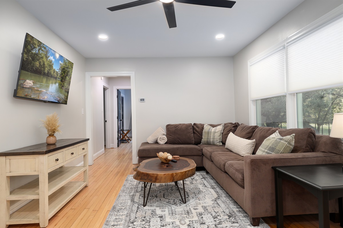 Living room with a large sectional and large screen tv so everyone can relax together