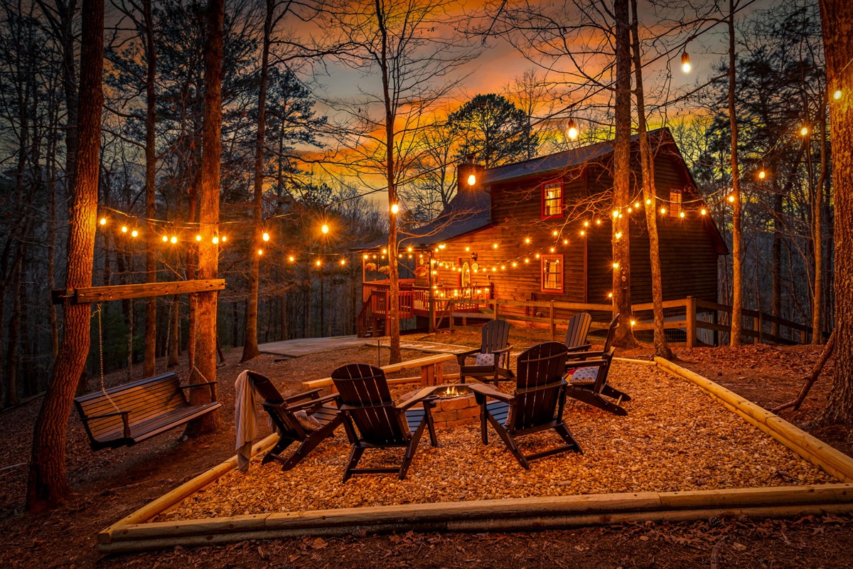 The outdoor fire pit area is thoughtfully designed with cozy seating and charming string lights, creating a warm and inviting ambiance. It’s the perfect spot to gather, relax, and enjoy memorable evenings under the glow of soft lighting and open skies.