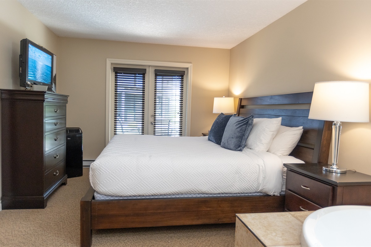 Unit A. Double glass doors leading to private patio right off bedroom. Note all the natural light. Soaker tub right in room!