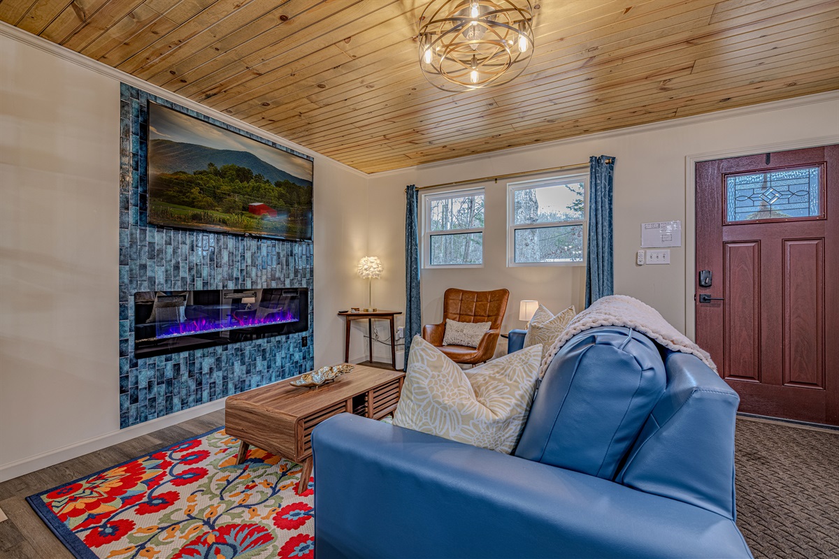 A bright and inviting space! Notice the warm wood plank ceiling that runs throughout the main level of the home.