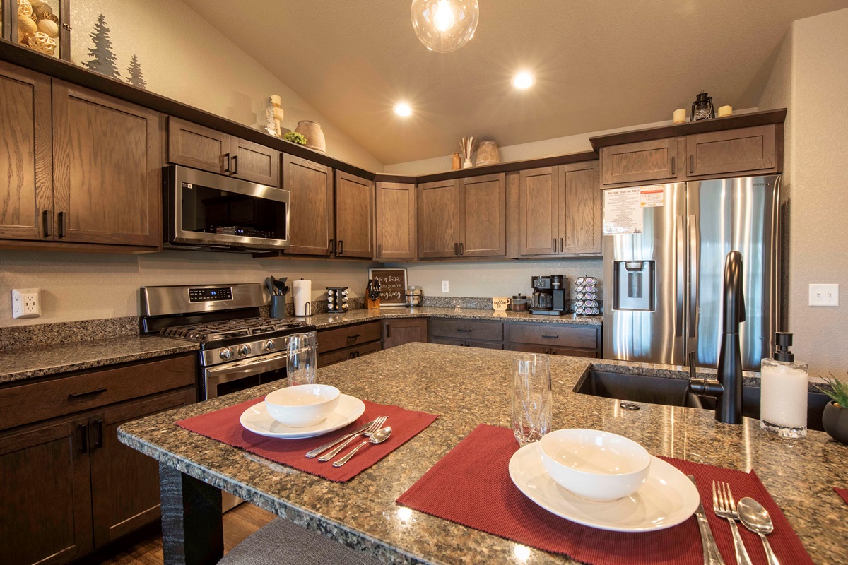 "On The Rocks" provides a powerful gas stove, stainless steel appliances, and a spacious granite island with bar stools in it's gourmet kitchen.