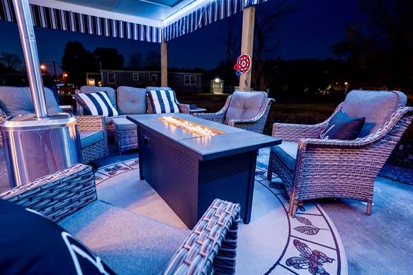 Enjoy a covered outdoor lounge with comfy seating, LED lighting, a fire table, patio heater, and a 65” outdoor TV. Perfect for relaxing, watching games, or spending time together year-round.