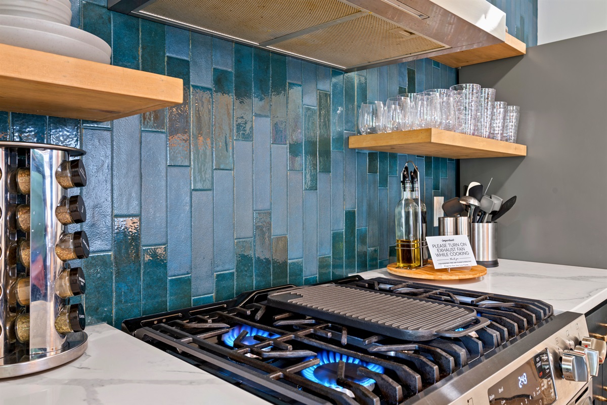 The stovetop and tile backsplash add a stylish touch, blending functionality with a bit of personality that elevates the overall space.