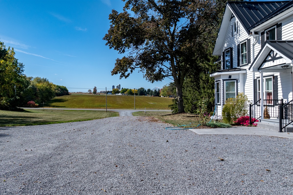 Peaceful driveway leading to open skies and lake views — welcome to your quiet country retreat