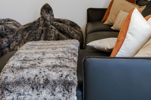 Soft throws, warm cushions and relaxed lounge seating give this upstairs media space a cosy alpine character at Fernhill Mountain Escape.
