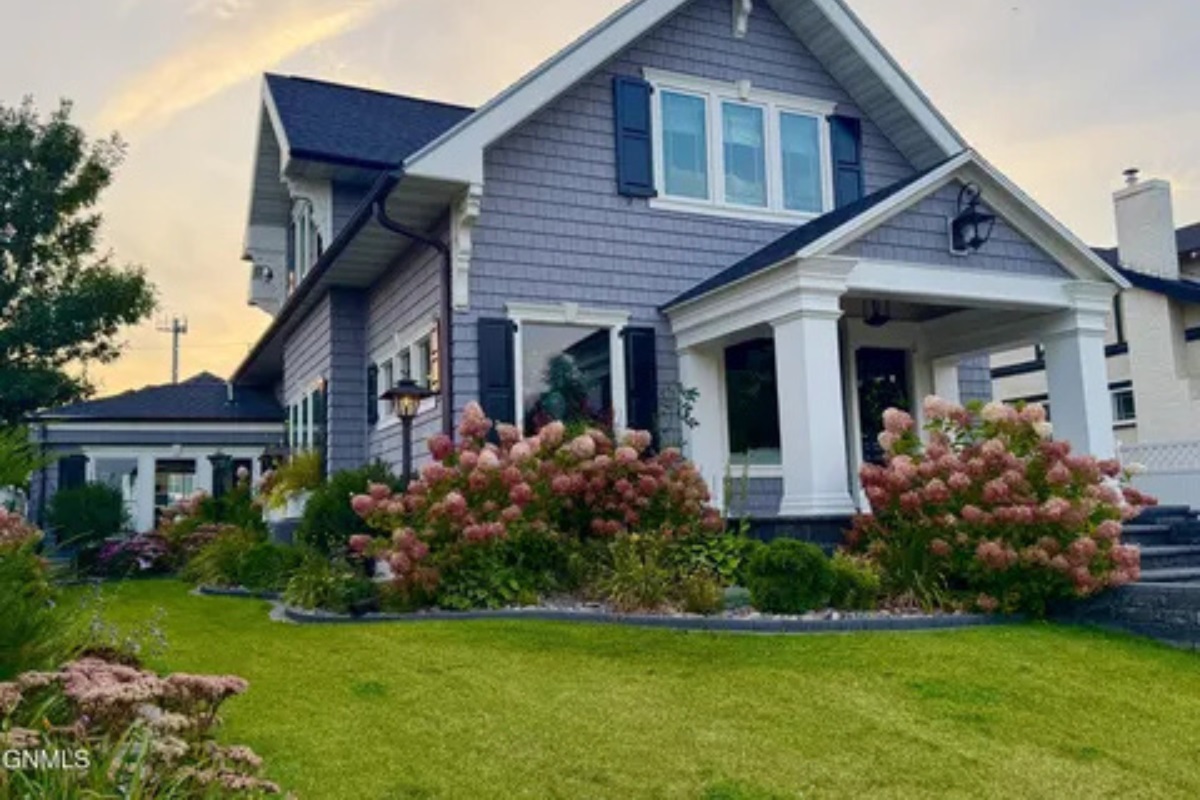 A charming front porch and blooming landscaping make this home feel welcoming from the moment you arrive.