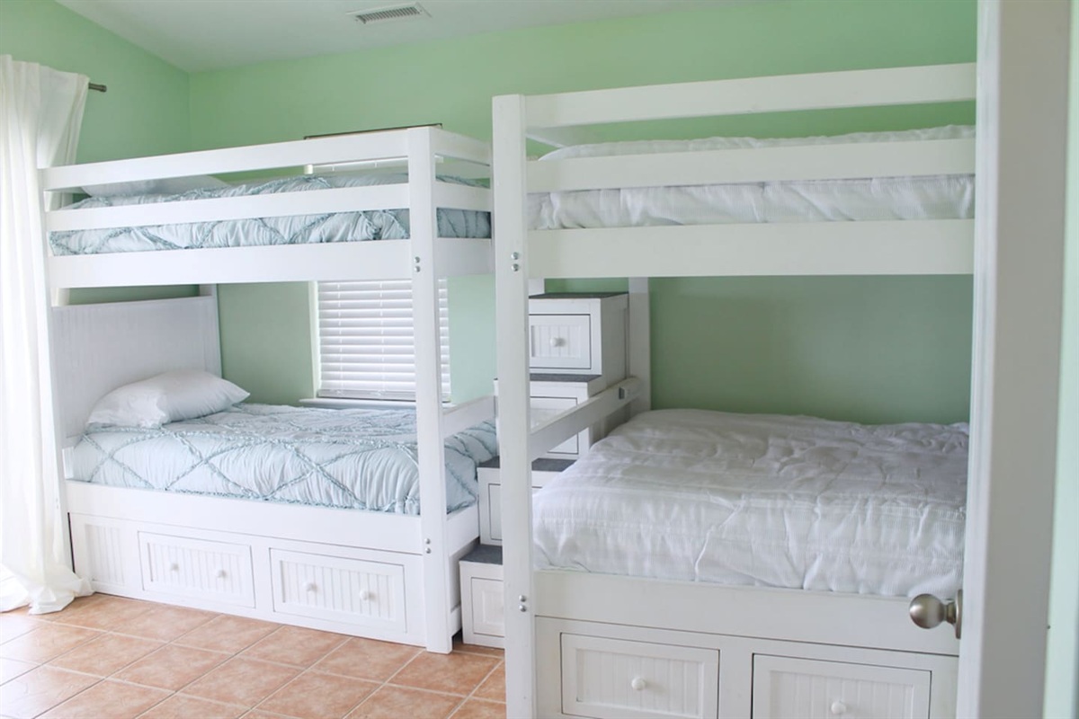 3rd floor bedroom located on back of house. Two full beds, two twin beds. Balcony access.