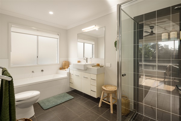 Private ensuite with full-size bath and seperate shower, designed for relaxed comfort.