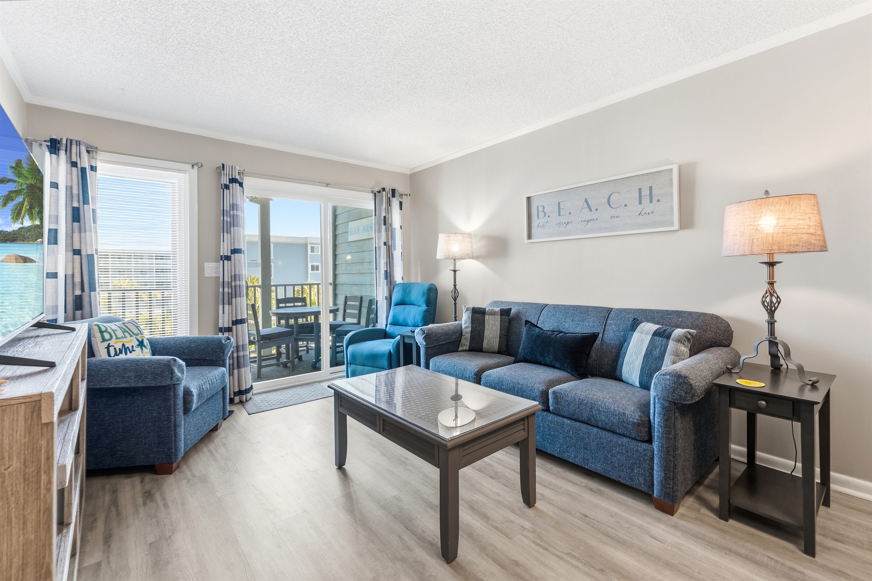 Spacious Living room with seating for everyone and balcony access